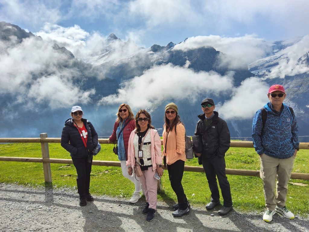 Hiking trail at Grindelwald First surrounded by alpine meadows and mountain scenery